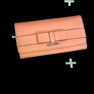 This is a Pink Nine West wallet. It’s has so many pockets and card holder places